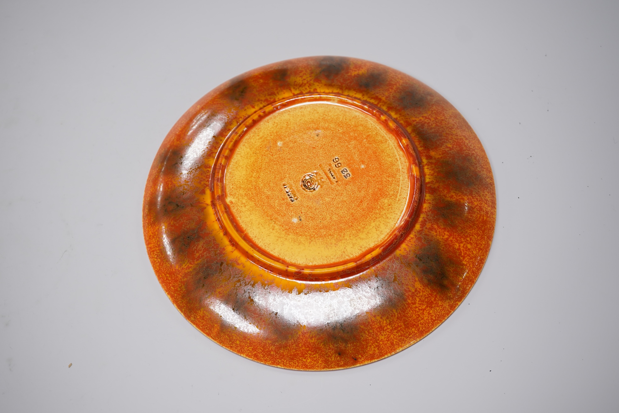 A Pilkingtons orange lustre plate, stamped to the base, 21cm in diameter